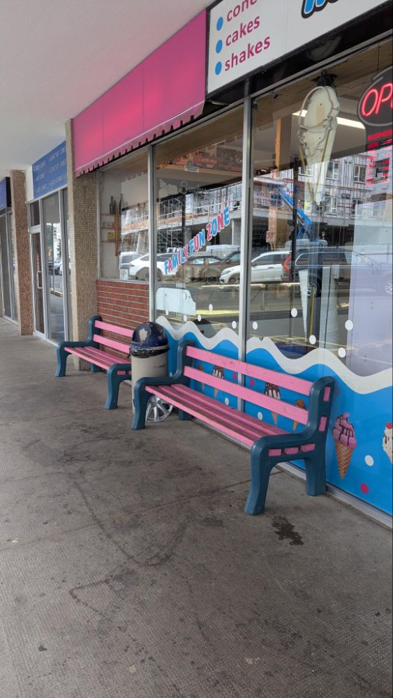 Photo of pink park benches in a strip mall walkway