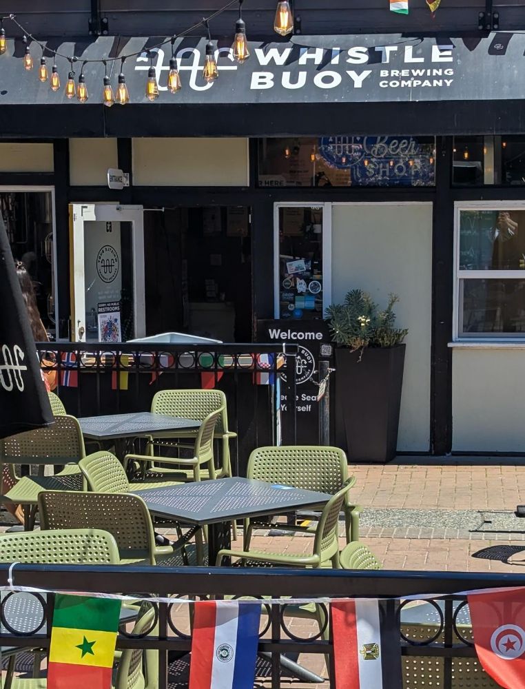 Photo of patio seating in front of the awning for Whistle Buoy